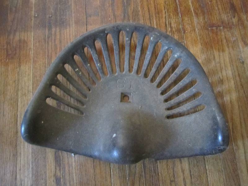 lot 34 image: Antique S1 tractor seat...