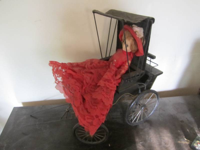 lot 40 image: Vintage doll in a buggy...