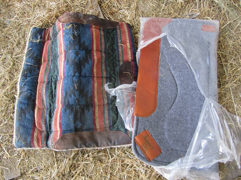 lot 606 image: 2 saddle pads, one new in the plast...
