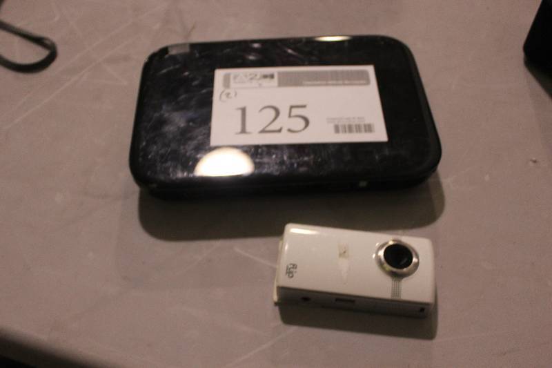 lot 125 image: Lot of (2) Electronics Including 1) Flip Video Camera AND 1) Logitech Revue