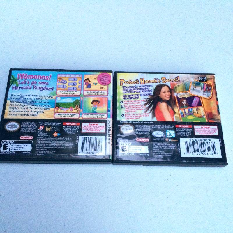 lot 12 image: 2 Nintendo DS Games Dora The Explorer Mermaids & Hanna Montana