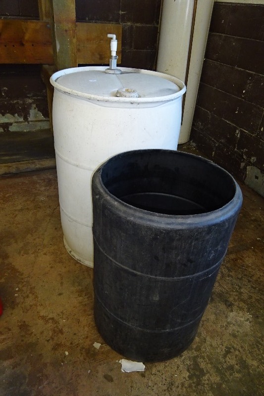 lot 8 image: 55 gallon barrel and black barrel