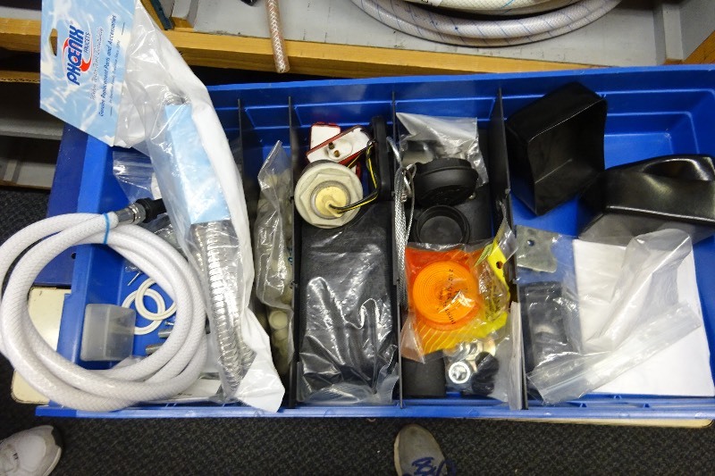 lot 131 image: Sink hose, trailer lenses, and misc. plumbing parts