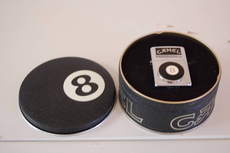 lot 133 image: 8 Ball Zippo and Tin