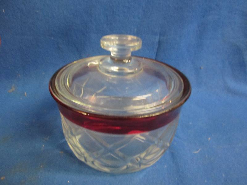 Red rimmed dish with lid...