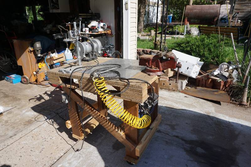 lot 4 image: Home Made Wheeled Work BenchTable With Mounted Vise, Compressor, Drill Press & Bench Grinder