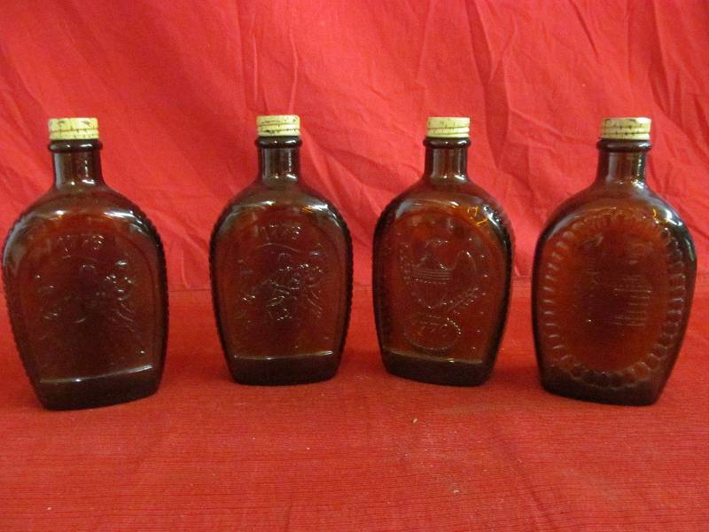 lot 110 image: Log Cabin Syrup bottles