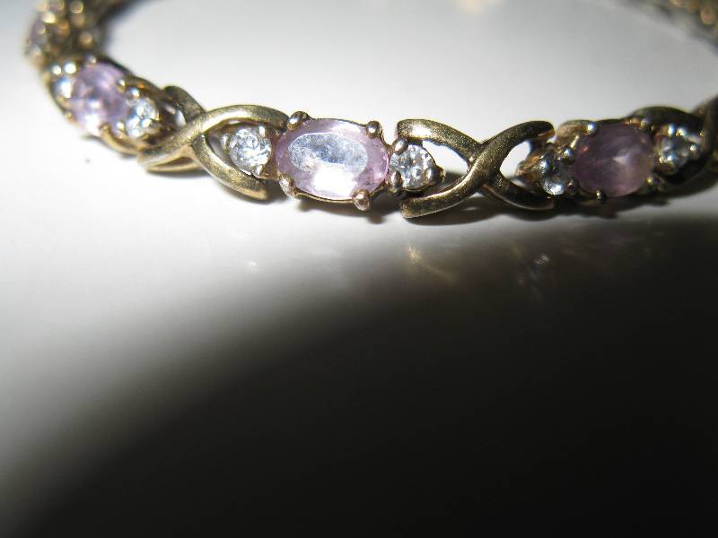lot 181 image: Gold bracelet wdiamond like and violet colored stones
