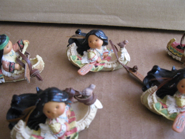 lot 217 image: 12 ceramic native american figurines in canoes
