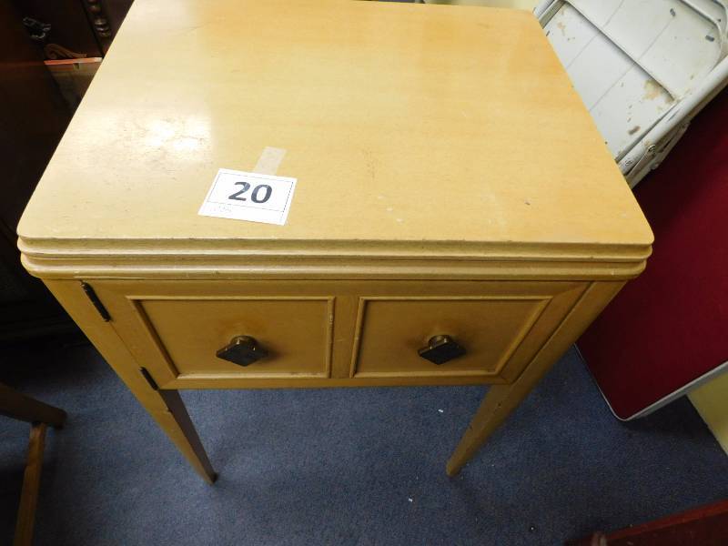 Vintage sewing machine in wood cabinet