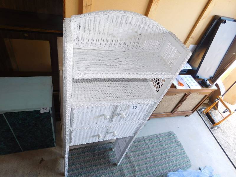 White wicker BR shelving unit used in the laundry room