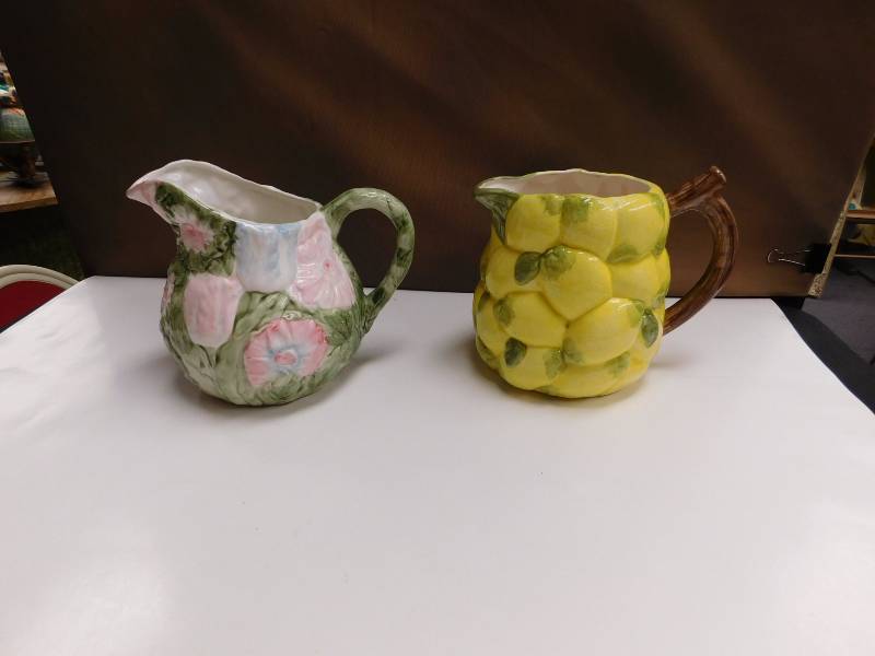 two pottery pitchers one made in Japan
