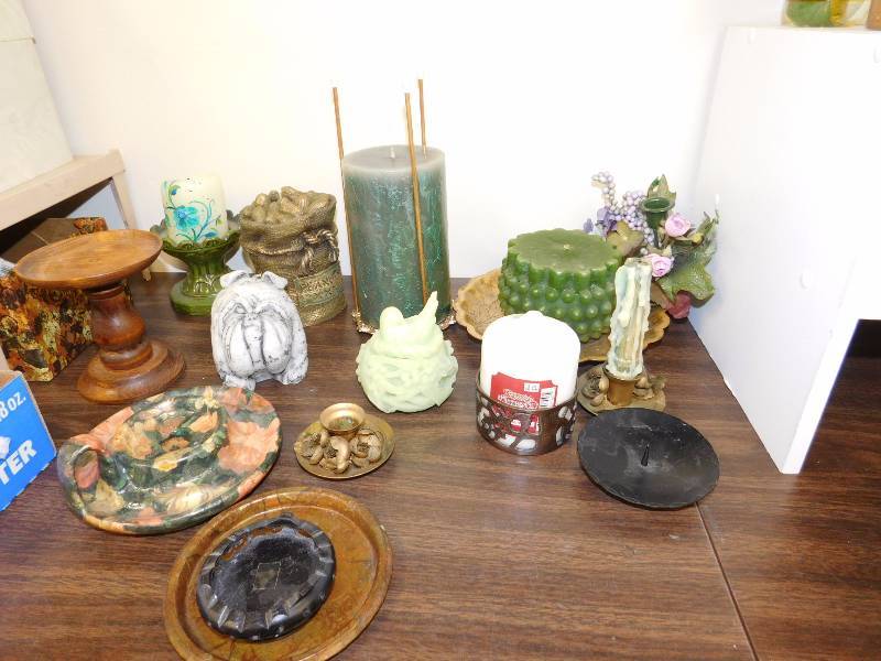 shelf lot of candles and various candle holders