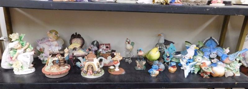 shelf lot of bird figurines and cottage figurines