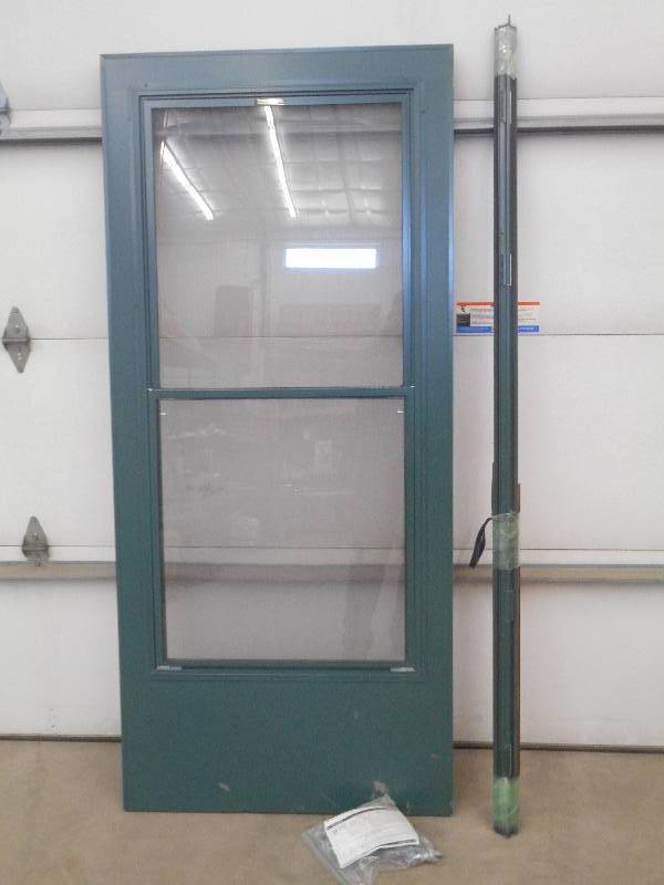 lot 64 image: Unused Pella 36 Storm Door Set Com...