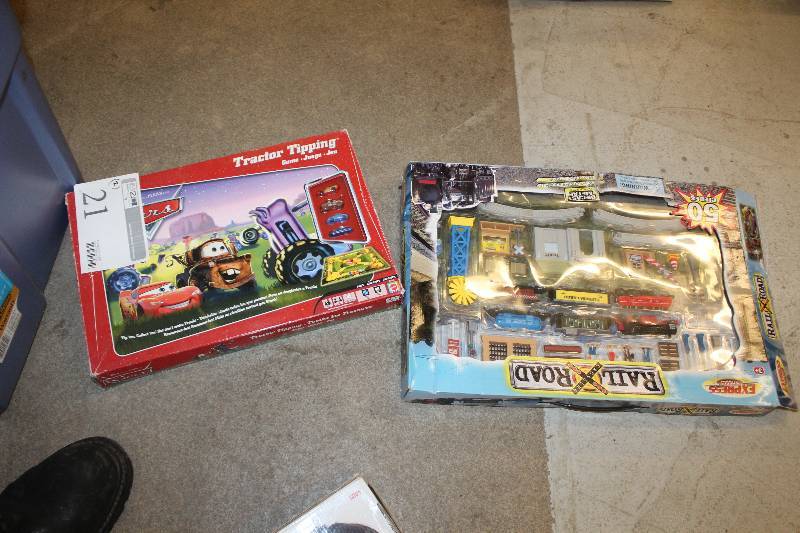 lot 21 image: Lot of (2) Kids Toys Including 1) Cars Tractor Tipping Game AND 1) Express Wheels RailRoad Crossing Diecast Set