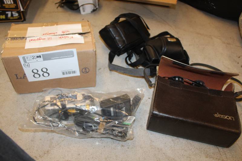 lot 88 image: Lot of (4) Electronics Including 1) Kodak 12M Digital Camera w Charger AND 1) Canon PowerShot G3 Digital Camera w Case AND 1) Jason Binoculars AND 1) Memory Stick Digital Still Camera