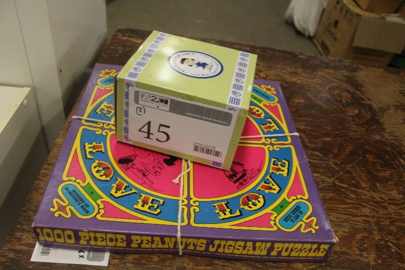 lot 45 image: Lot of (2) Peanuts Memorabilia Including 1) 1000-Piece Panuts Jigsaw Puzzle AND 1) Looking For Lucy Saint Pauls Tribute To Charles M. Schulz