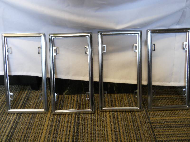lot 17 image: FOUR (4) Metal License Plate Frames