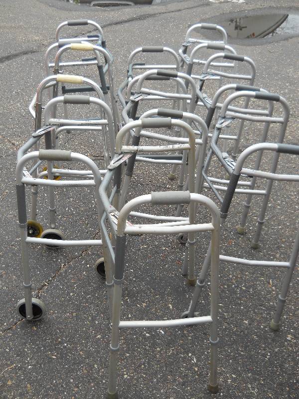 lot 33 image: LOT of 9 Folding Walkers  some with wheels, some stationary