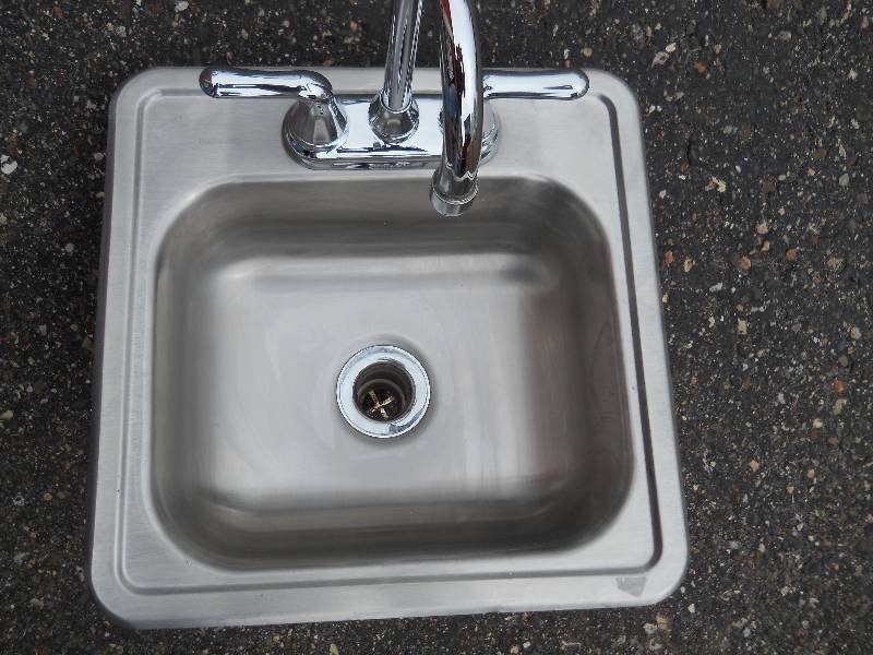 lot 48 image: KINGSFORD Stainless Steel Drop in sink with American Standard faucet and 2 water braided water hoses