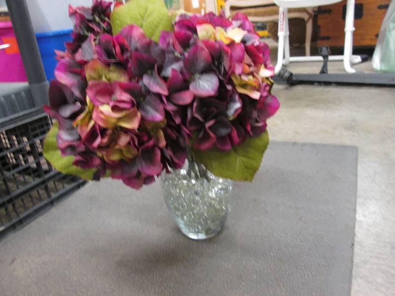 Artificial hydrangeas in glass vase...