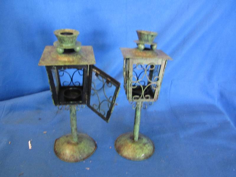 lot 110 image: Pair of metal candle holders...