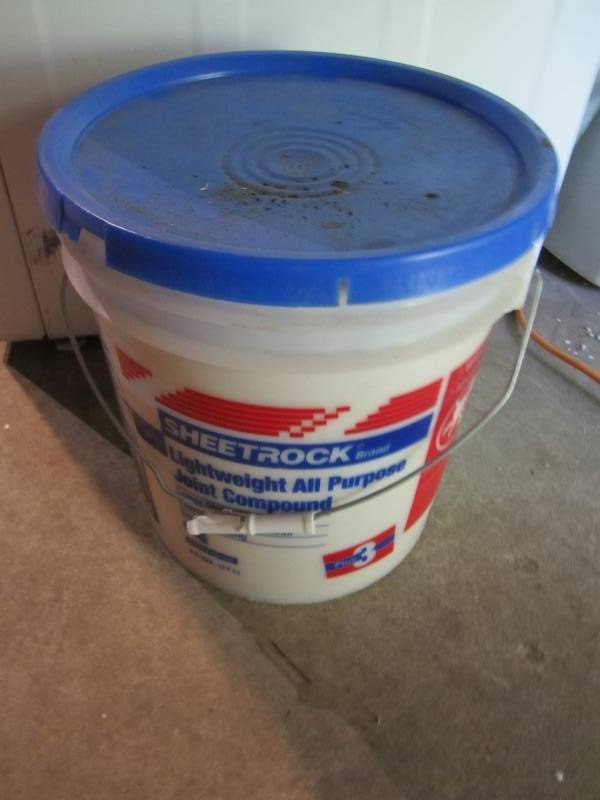 lot 217 image: About half a pail of drywall mud...