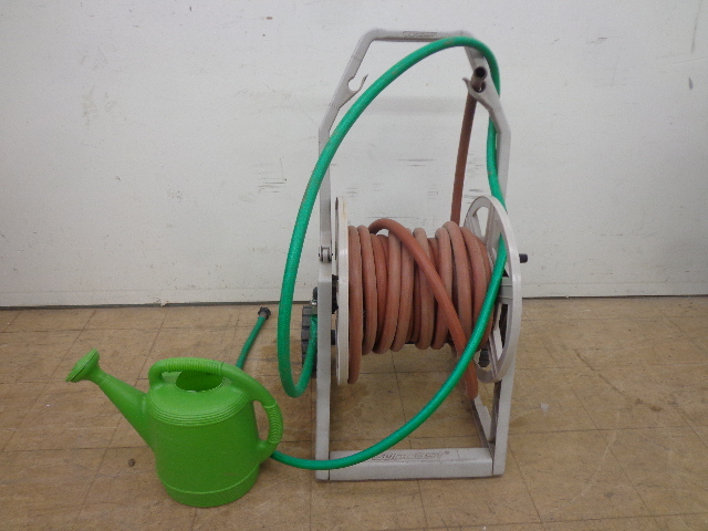 lot 77 image: Garden Hose, Reel & Plastic Watering Can
