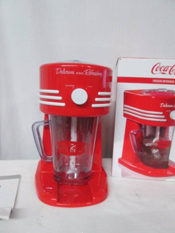lot 50 image: Nostalgia Electrics Coke Frozen Beverage Maker