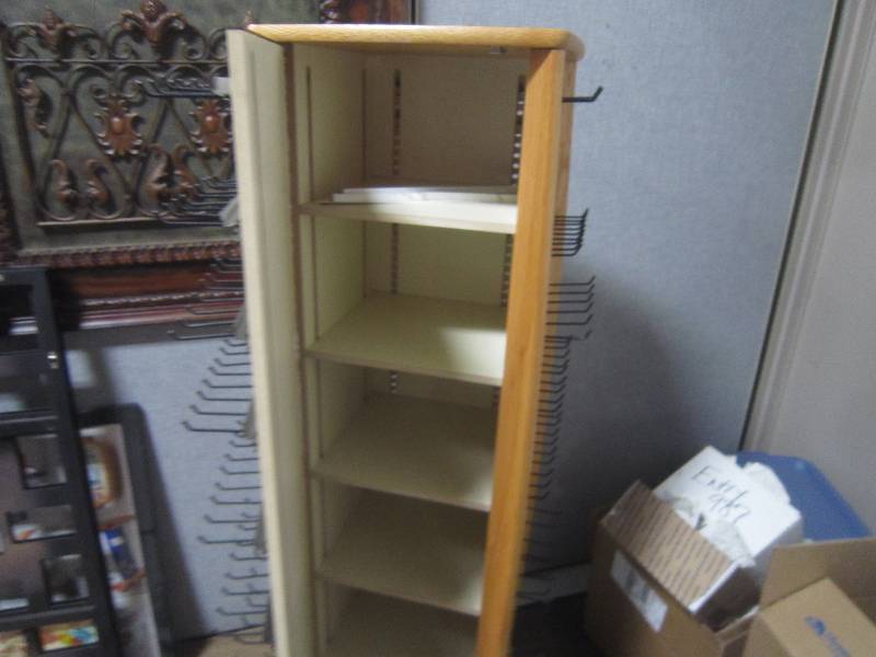 ROTATING DISPLAY RACK WITH ADJUSTABLE PEGS AND STORAGE INSIDE  ON WHEELS