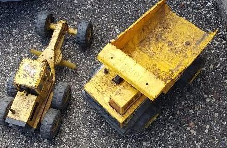 Two yellow metal Tonka trucks