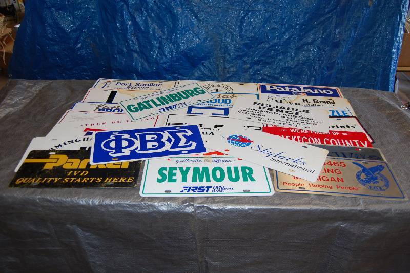 lot 105 image: Metal Advertising License Plates