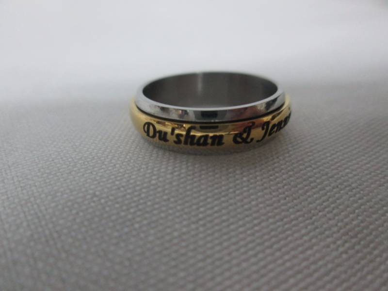 lot 84 image: Ladies Stainless Steel Personalized Couples Spinner Band