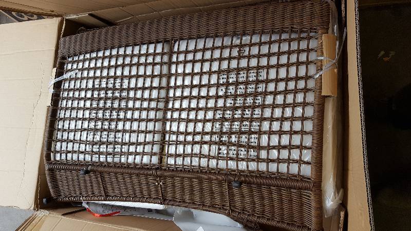 lot 22 image: Spring Haven Brown Wicker Patio Loveseat with Cushion Insert (Slipcovers not included)