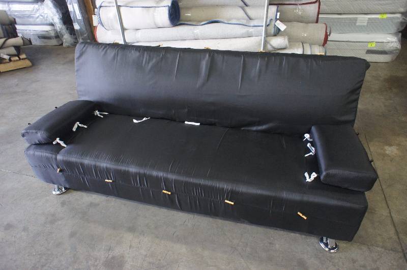 lot 11 image: 73 Black Click Clack Sofa. Some damage to back left corner.