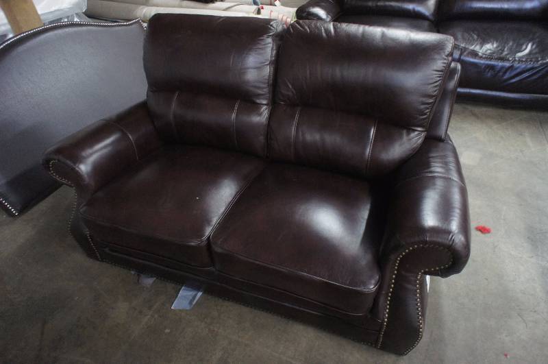 lot 14 image: 68 High End Reddish Brown Leather Loveseat, missing feet and some minor damage.