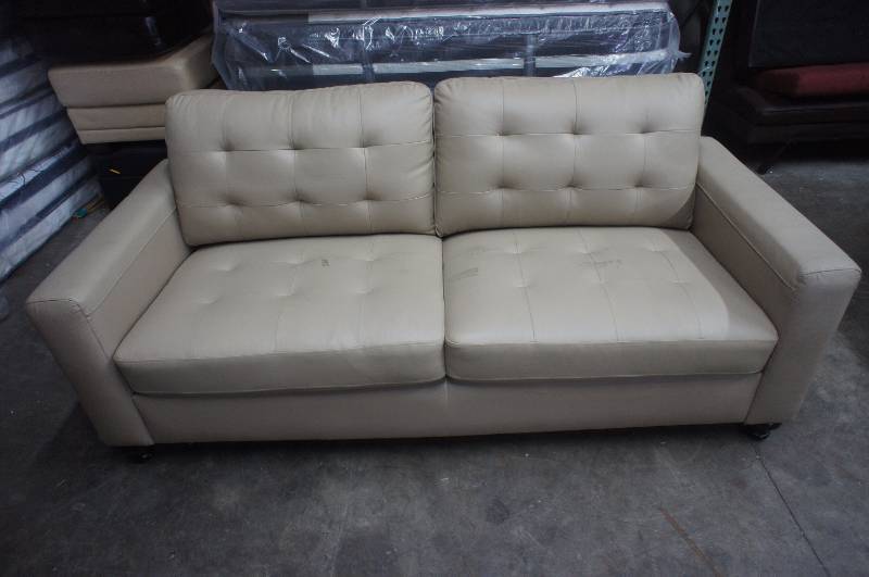 lot 16 image: 79 High End Beige Leather Sofa, some minor blemishes to cushions. Dimensions 79W X 36D X 30T