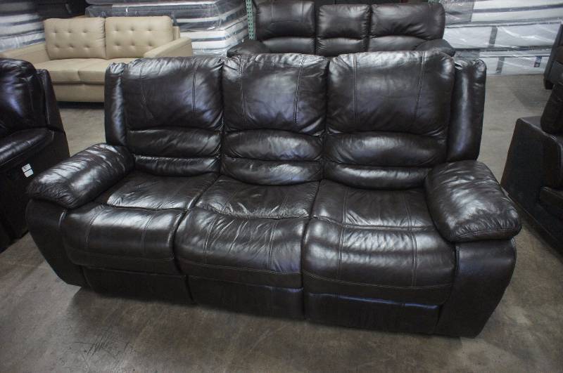 lot 19 image: 78 High End Brown Leather Reclining Sofa. Dimensions 78W X 35D X 36T