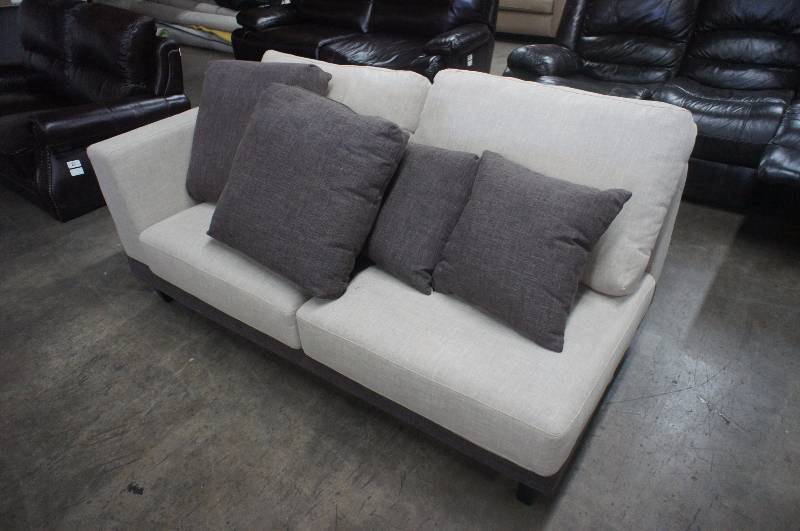lot 22 image: 68 High End Beige Fabric Love-seat  with Pillows. Dimensions 68W X 37D X 27T