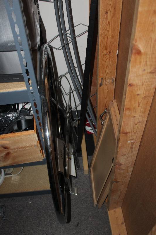 lot 254 image: Remaining Contents of Closet Including Table, Display Rack, Chair, Frames, Wood, And More