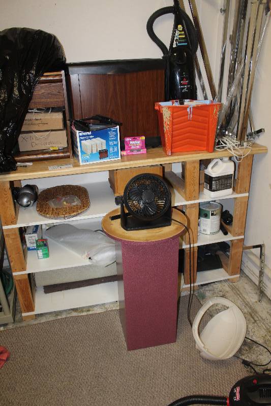 lot 271 image: Contents of 3-Shelf Book Shelf Including Fan, Filters, Decorations, Mats, Radio, Fan, Chemicals, Paint, Cords, And More