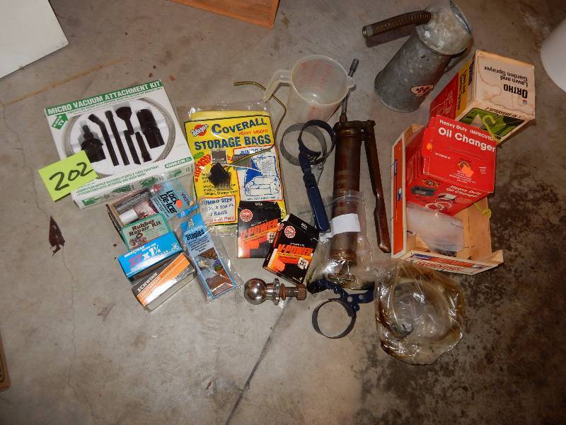 lot 202 image: Misc. Auto and Bicycle items.. Vintage Oil Can  Grease Gun, Spark plugs, Bicycle inner tubes and more.. See closeups