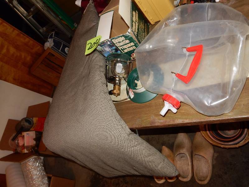 lot 204 image: Chair pad, Coleman propane single wick lantern (no propane tank) Collapsible plastic water tank.