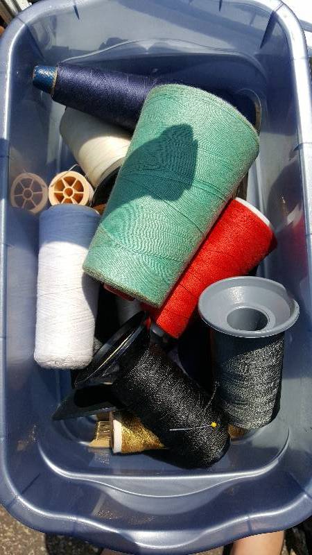 Lot of nine rolls of string with plastic tub