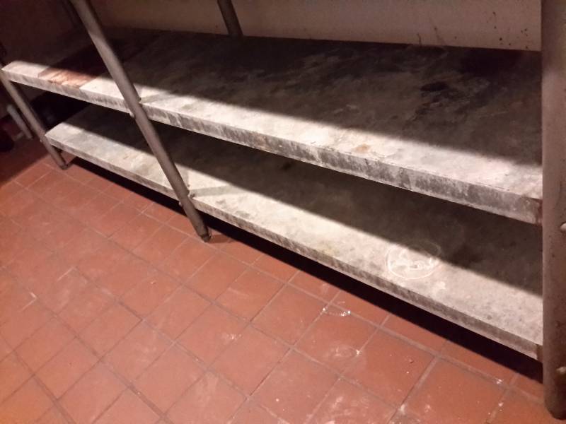 8 ft stainless steel table. 24in h deep with 6in backsplash. 36in h.  2 galvanized shelves.