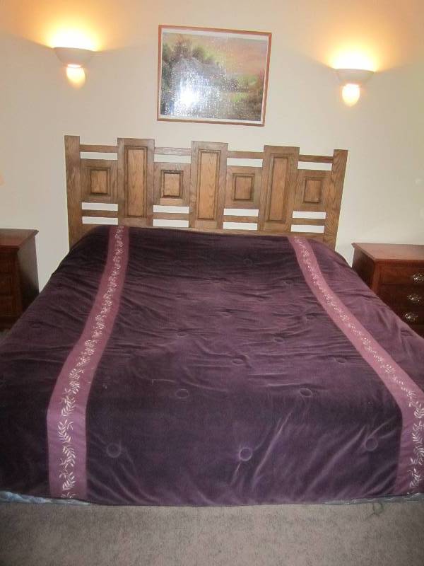 King size bed, complete with sheets...