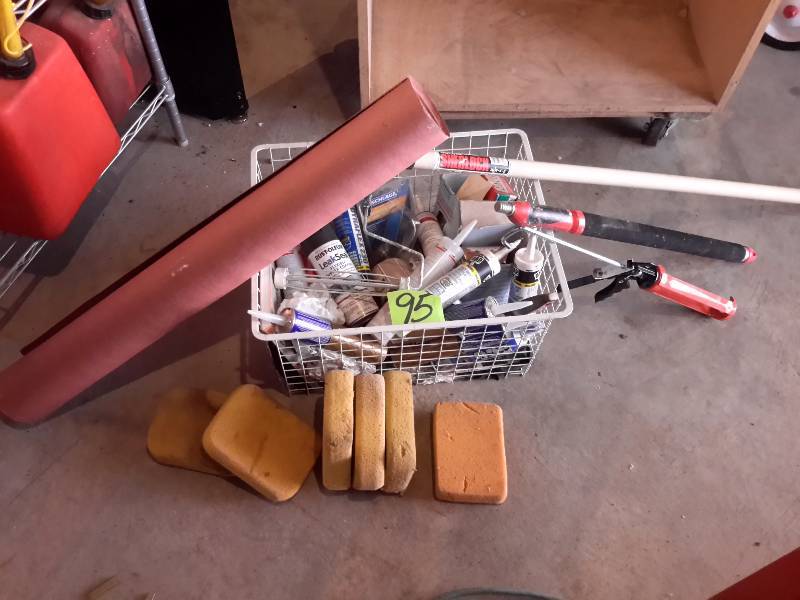lot 95 image: Misc. Painting items.. Partial Roll of Red Rosin Paper, 6 sponges, 2 Telescoping Roller handles, Caulk and Caulk guns.. Lots of other things in the basket.. Take it all.