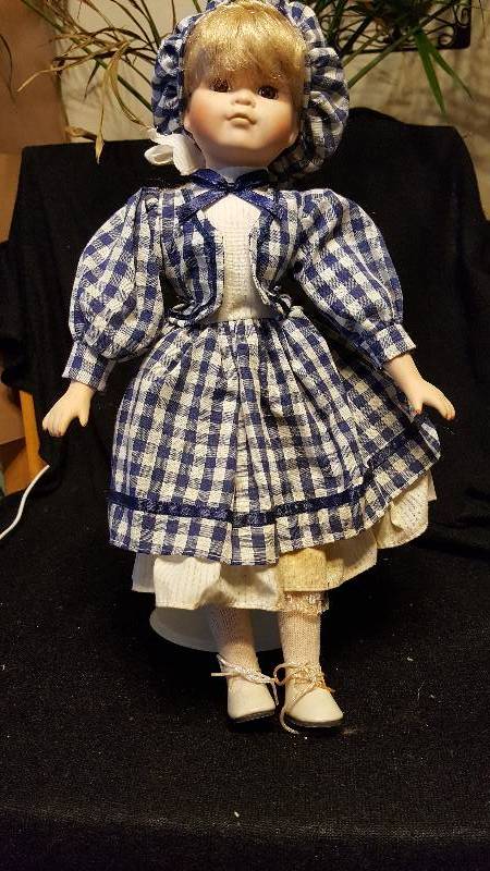 Blonde poreclain doll with blue dress and hat