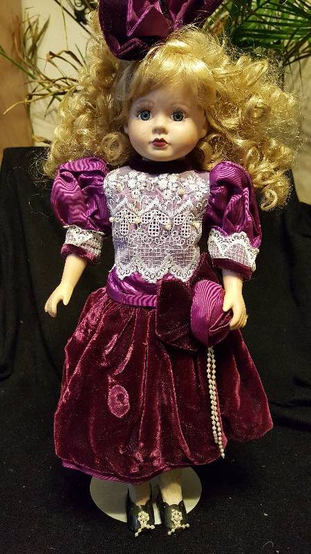 Vintage blonde porcelain doll with big bow in hair